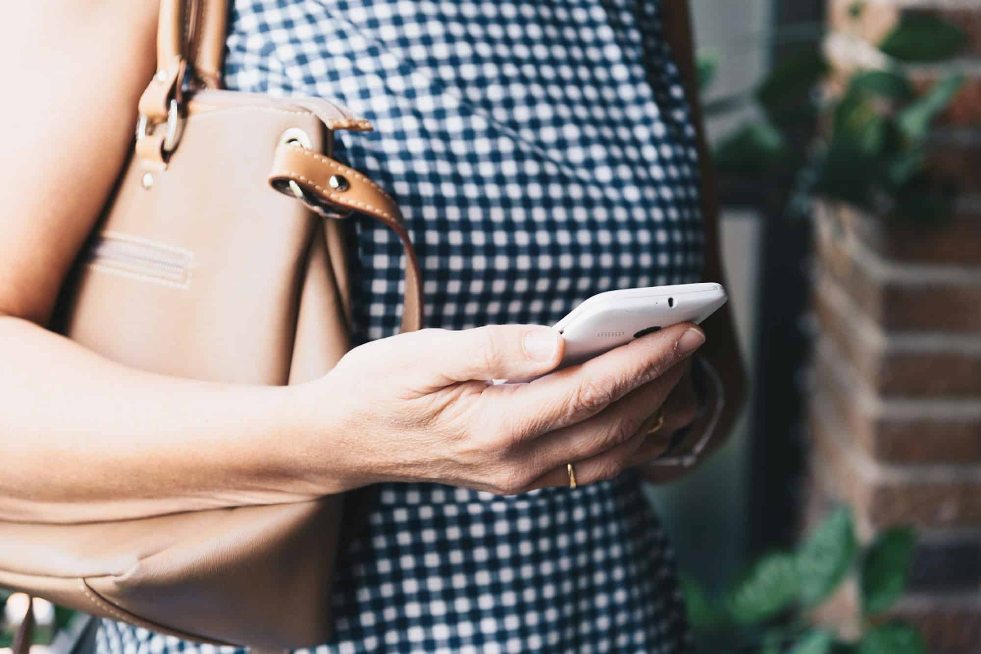 Closeup photo of stylish woman with cellphone